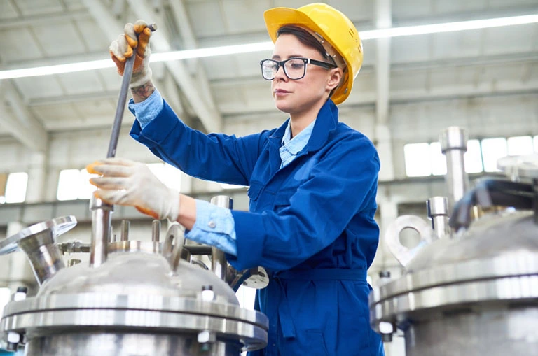 Ingeniera química operando equipos industriales en planta de producción
